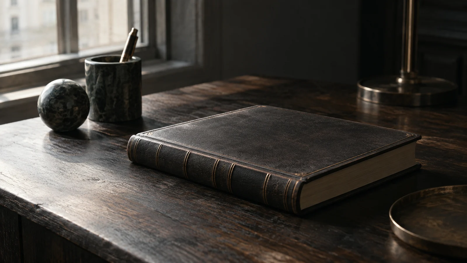 Conceptual photograph: A bound blank archival ledger on a dark oak table under a narrow pool of daylight